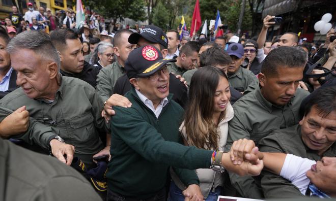 Colombias president Gustavo Petro (i keps) omgiven av anhängare vid en första maj-demonstration i huvudstaden Bogotá.