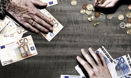 3 generations of hands with euro coins and notes on table