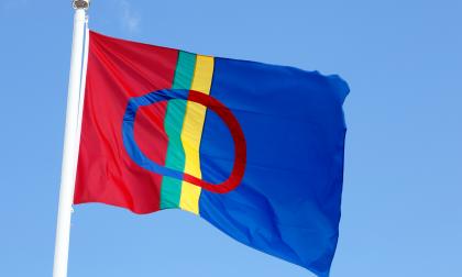 The Sami flag isolated on clear blue sky.
