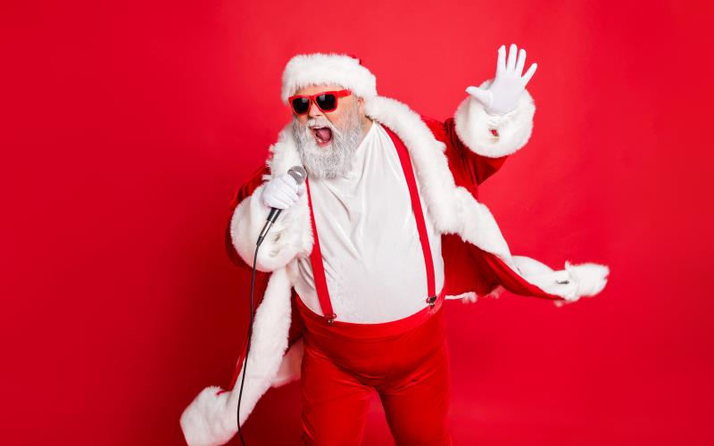 Portrait of cool funny fat overweight santa claus with big belly sing song on christmas party wear style stylish trendy eyeglasses eyewear, hat isolated over red background