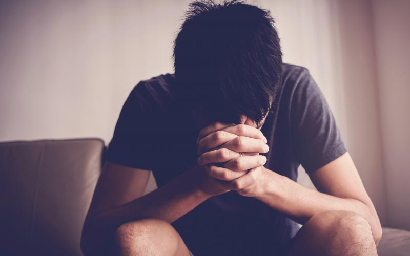 Depressed, despair and anxiety young man sitting alone and praying at home, mental health, men health, praying christian  concept