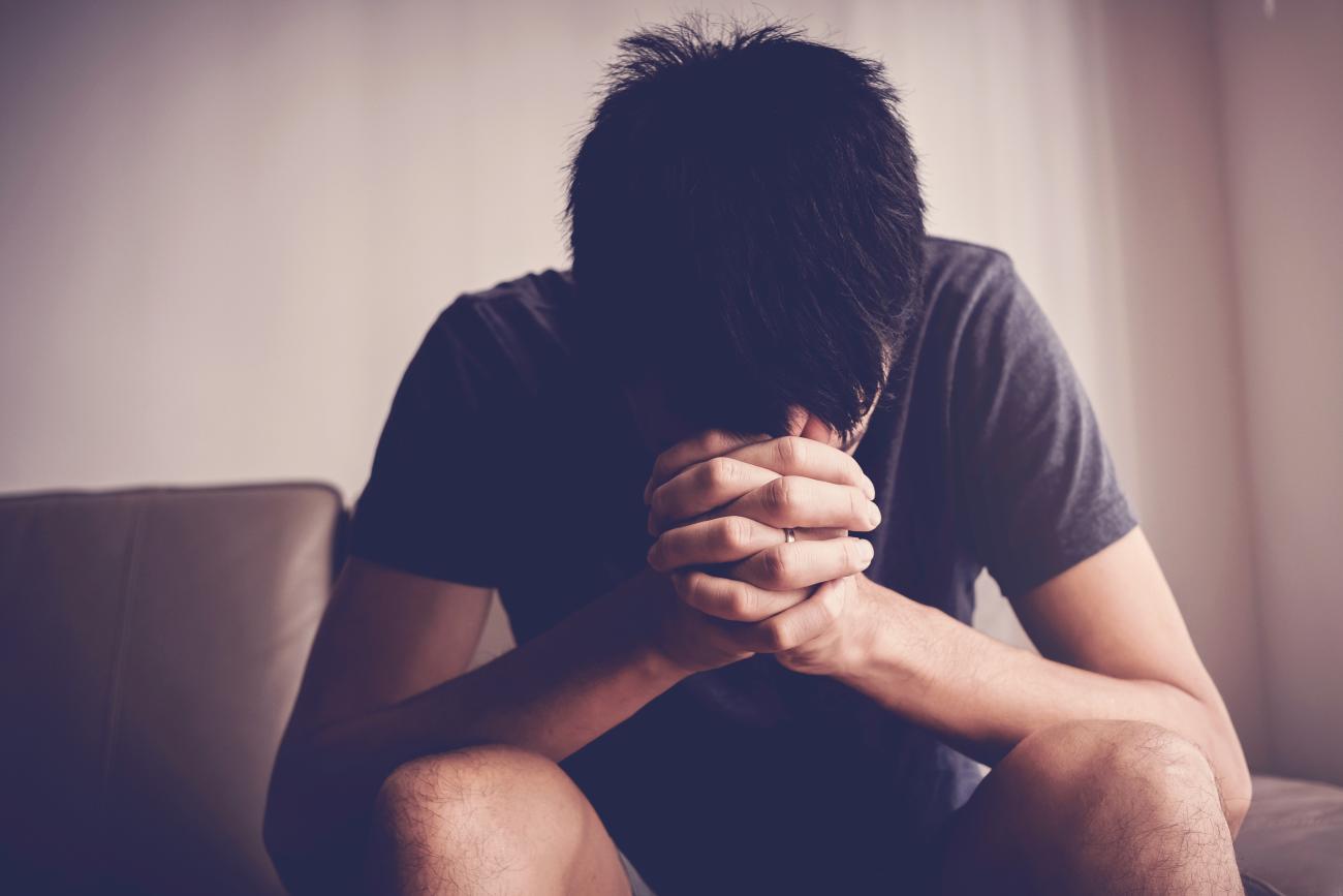 Depressed, despair and anxiety young man sitting alone and praying at home, mental health, men health, praying christian  concept