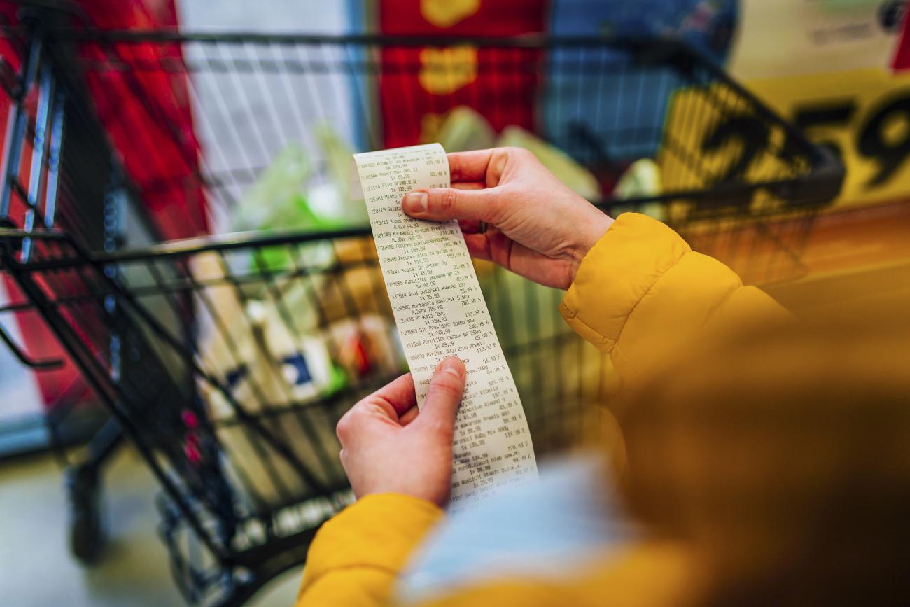 Woman checking the bill when paying at a supermarket